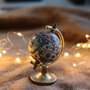 small earth globe surrounded by fairy lights